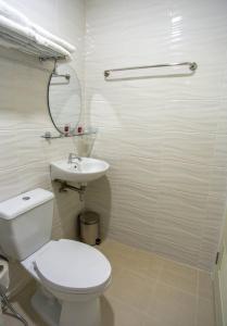 a white bathroom with a toilet and a sink at TP Residence เคหะร่มเกล้า in Lat Krabang +19 photos