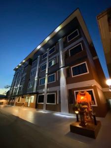 a building with a fountain in front of it at TP Residence เคหะร่มเกล้า in Lat Krabang