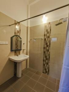 a bathroom with a sink and a shower at Shalom Resort in Avissawella +42 photos