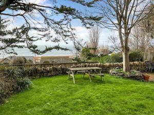a picnic table in the grass in a yard at Mimosa - Uk51224 in Swyre