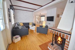 a living room with a couch and a fireplace at "Hasselbacken" in Vimmerby