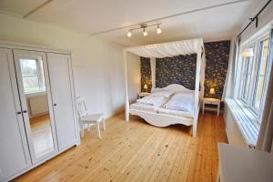 a bedroom with a bed with a canopy at "Hasselbacken" in Vimmerby