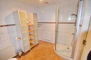 a bathroom with a shower and a tiled floor at "Hasselbacken" in Vimmerby +32 photos