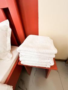 a pile of white towels sitting on a table at Bekarys Hotel in Astana