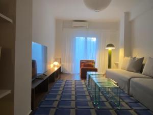 a living room with a couch and a table at RYB Colour Apartment in Patra
