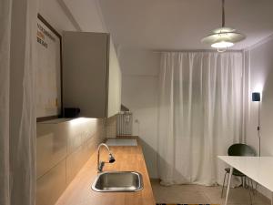 a kitchen with a sink and a counter at RYB Colour Apartment in Patra +99 photos