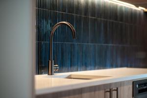 a kitchen sink with a faucet in a bathroom at Luna Lodge Wānaka - digital check-in only in Wanaka +54 photos