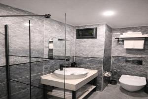 a bathroom with a sink and a toilet at Nas Corner Hotel in Antalya +43 photos