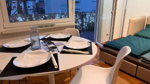 a table with plates and napkins on it in a room at Cute apartment in lovely Constance in Konstanz +18 photos