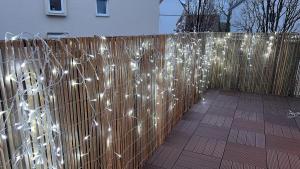 a wooden fence with white lights on it at Cute apartment in lovely Constance in Konstanz