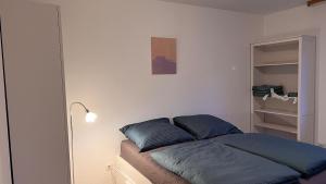 a bed with blue pillows in a bedroom at Cute apartment in lovely Constance in Konstanz