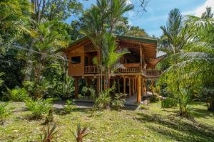 a wooden house in the middle of a forest at Charming Villa Surrounded by Nature Punta Uva in Puerto Viejo