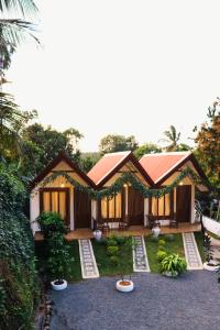 a small house with a garden in front of it at Shalom Resort in Avissawella