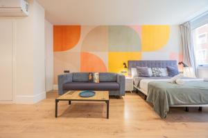 a living room with a couch and a table at BILBAO RIVERSIDE by STAYNN APARTMENTS in Bilbao