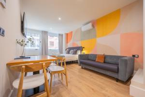 a living room with a couch and a table at BILBAO RIVERSIDE by STAYNN APARTMENTS in Bilbao