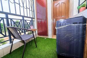 a balcony with a chair and a trashcan and a door at GoldKent Kileleshwa in Gatunga