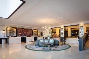 a lobby of a hotel with a table and chairs at Conrad Dublin in Dublin