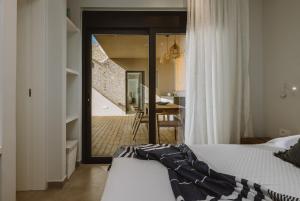 a bedroom with a bed and a view of a staircase at Villa Morby in Paleros +23 photos
