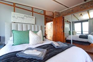 a bedroom with a large bed with a tray on it at Hidden Gem in Cape Town +26 photos