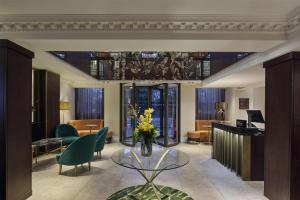 a lobby with a vase of flowers on a glass table at Hilton London Hyde Park in London