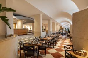 a row of tables and chairs in a restaurant at Hilton Rome Airport in Fiumicino