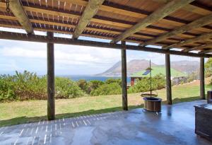 an open patio with a view of the ocean at Hidden Gem in Cape Town