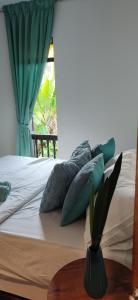 a bedroom with a bed with pillows and a window at LumaYan, Guesthouse and Cabin in Yan +56 photos