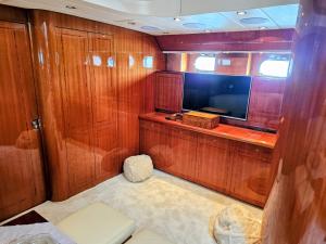 a small room with a television and wooden walls at Private Yacht Monaco in Monte Carlo +5 photos