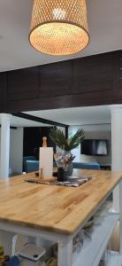 a dining room table with a light fixture at LumaYan, Guesthouse and Cabin in Yan