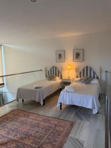 two beds in a room with a rug at Duplex Botánico Resort in Estepona +34 photos