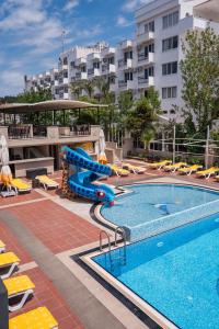 a swimming pool with a water slide in a hotel at Buyuk Berk Hotel in Ayvalık