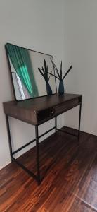 a wooden table with two plants on top of it at LumaYan, Guesthouse and Cabin in Yan