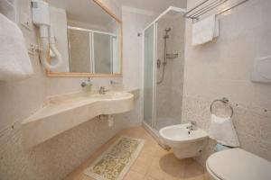 a bathroom with a sink and a toilet at Hotel Excelsior in Cattolica +25 photos