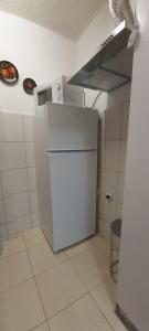 a small kitchen with a white refrigerator in a room at Студио in Shumen
