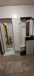 a room with a bathroom with a sink and a mirror at Студио in Shumen