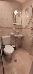 a bathroom with a toilet and a sink at Студио in Shumen