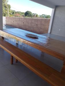 a wooden table with a glass top on top at Casa linda buzios in Búzios