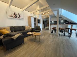 a living room with a couch and tables and a kitchen at B&K Immobilien GbR in Tangermünde