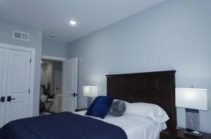 a bedroom with a bed with a dog laying on it at Big apple room 35 in West New York