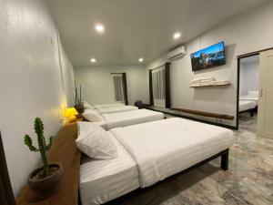 a bedroom with two beds and a cactus in it at สวนธรรมคยา in Ban Dan Chang