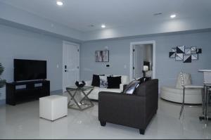 a living room with a couch and a tv at Big apple room 35 in West New York