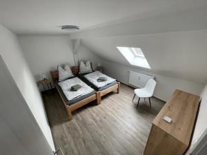 an overhead view of a bedroom with a bed and a chair at B&K Immobilien GbR in Tangermünde