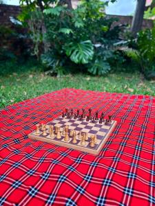 a chess board on top of a red blanket at Fig Tree Rock 2-bed, 2-bath villa with garden and parking in Nelspruit +34 photos