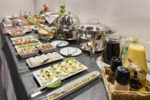 a buffet with many different types of food on a table at Hotel Nowa Panorama in Krakow