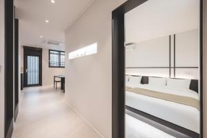 a bedroom with a white bed and a sliding glass door at GOYURe 고유리 in Seoul +29 photos