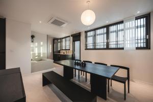 a dining room with a black table and chairs at GOYURe 고유리 in Seoul