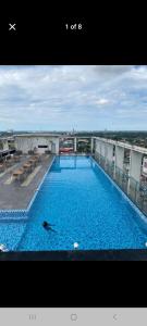 a person swimming in a large pool on top of a building at D Elite in Kota Bharu