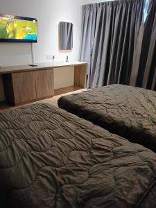 a bedroom with a bed and a flat screen tv at D Elite in Kota Bharu