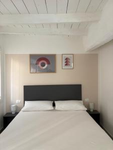 a bedroom with a large white bed with two night stands at Terrazza Montegrappa in Reggio Emilia