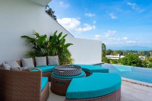 a patio with wicker furniture and a swimming pool at Stunning X Space Villa Sea View Infinity Pool in Koh Samui